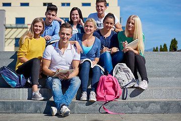 Image showing students outside sitting on steps