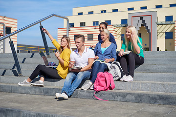 Image showing students outside sitting on steps