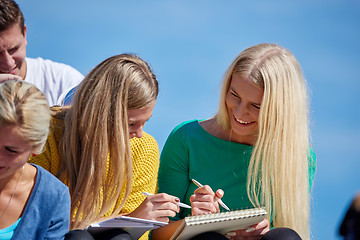 Image showing students outside sitting on steps