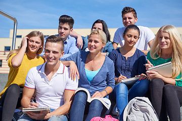 Image showing students outside sitting on steps