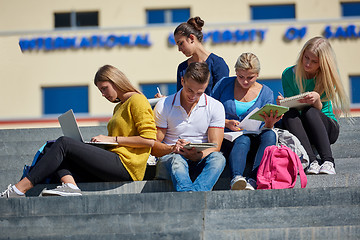 Image showing students outside sitting on steps