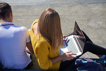 Image showing students outside sitting on steps