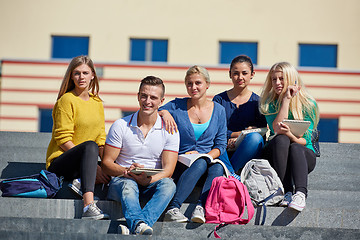 Image showing students outside sitting on steps