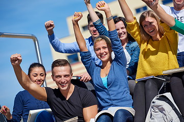 Image showing students outside sitting on steps