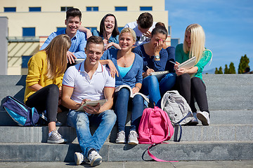 Image showing students outside sitting on steps