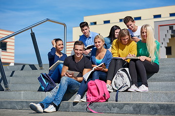 Image showing students outside sitting on steps