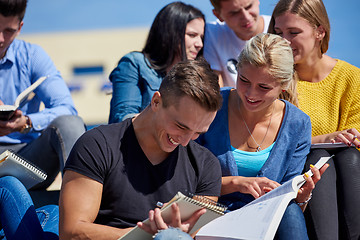 Image showing students outside sitting on steps