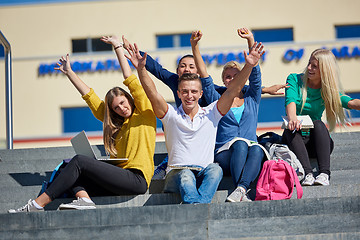 Image showing students outside sitting on steps