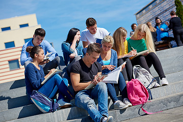 Image showing students outside sitting on steps