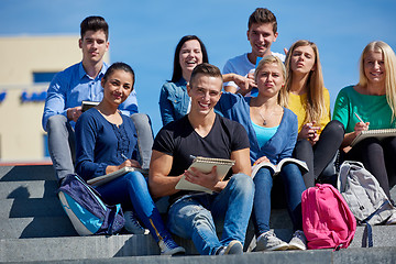 Image showing students outside sitting on steps