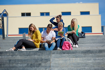 Image showing students outside sitting on steps