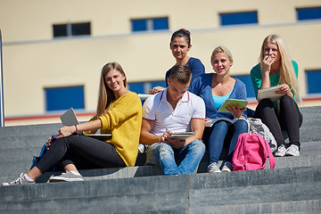 Image showing students outside sitting on steps