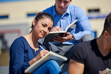 Image showing students outside sitting on steps