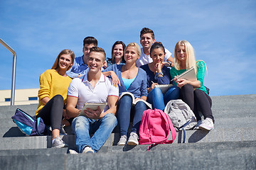 Image showing students outside sitting on steps