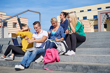 Image showing students outside sitting on steps