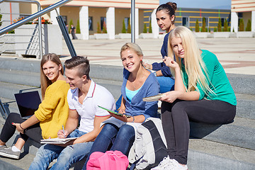 Image showing students outside sitting on steps