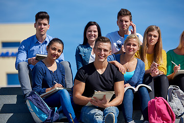 Image showing students outside sitting on steps