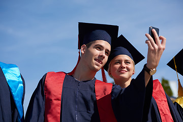 Image showing students group in graduates making selfie