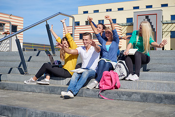 Image showing students outside sitting on steps