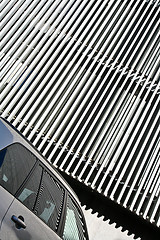 Image showing Car and stripes, car parked in front of a building with striped 