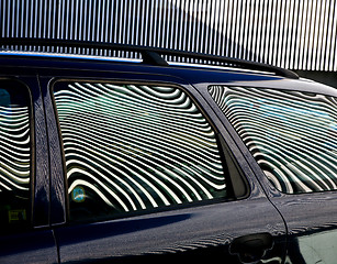 Image showing Car and stripes, car parked in front of a building with striped 