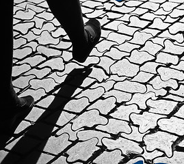 Image showing Walking legs on pavement in the sun, with shades