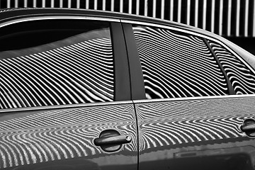 Image showing Car and stripes, car parked in front of a building with striped 