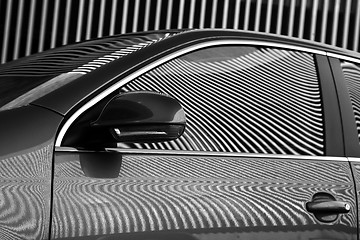 Image showing Car and stripes, car parked in front of a building with striped 