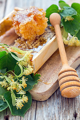 Image showing Linden blossom, honey and wooden spoon.