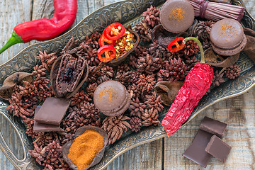 Image showing French almond cakes, chocolate and chili peppers.