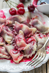 Image showing Dumplings with fresh cherries.