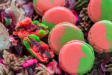 Image showing Macarons stuffed with chocolate and berries.