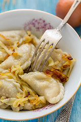 Image showing Fork in a bowl of dumplings.