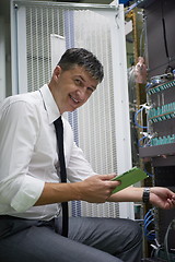 Image showing network engineer working in  server room