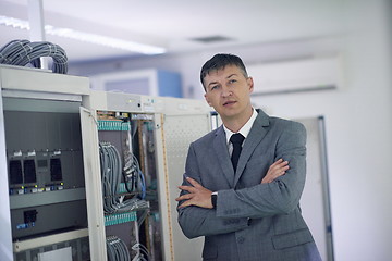 Image showing network engineer working in  server room