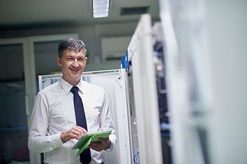 Image showing network engineer working in  server room