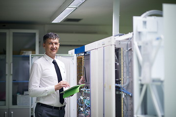 Image showing network engineer working in  server room