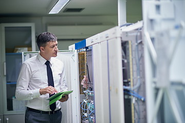 Image showing network engineer working in  server room