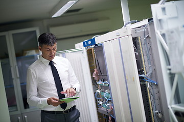 Image showing network engineer working in  server room