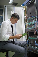 Image showing network engineer working in  server room