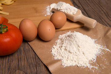 Image showing Flour spoon and eggs