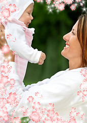 Image showing happy mother with baby and flowers