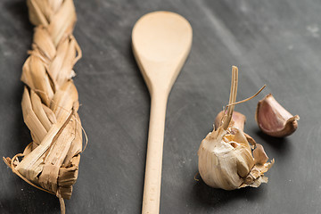 Image showing Wooden spoon and garlic 