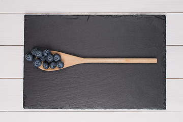 Image showing Blueberries on a wooden spoon