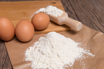 Image showing Flour spoon and eggs