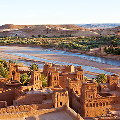 Image showing sunset in africa old construction near the river blue