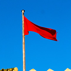 Image showing tunisia  waving flag in the blue sky  colour and battlements  wa