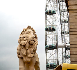 Image showing lion  london eye in the spring sky and white clouds