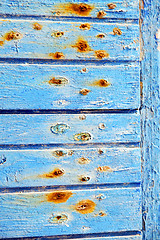 Image showing stripped paint in   blue wood red