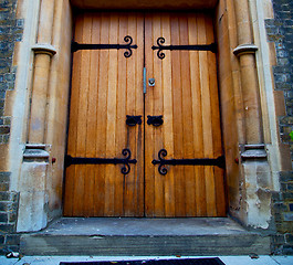 Image showing wooden parliament in london old church door and marble antique  